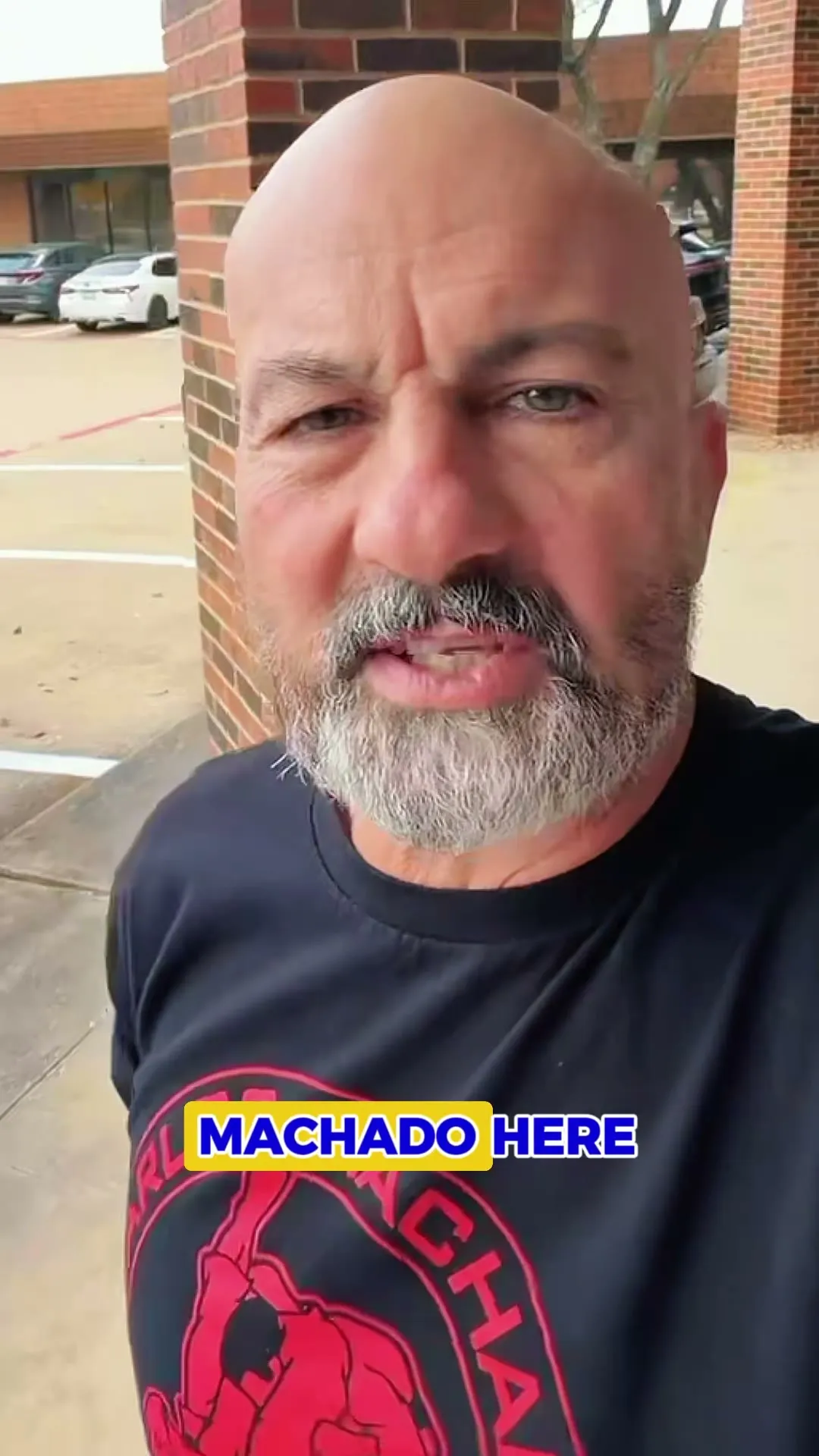 Master Carlos Machado speaking to camera outside the academy